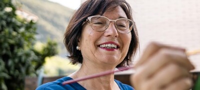 stock image of smiling woman painting